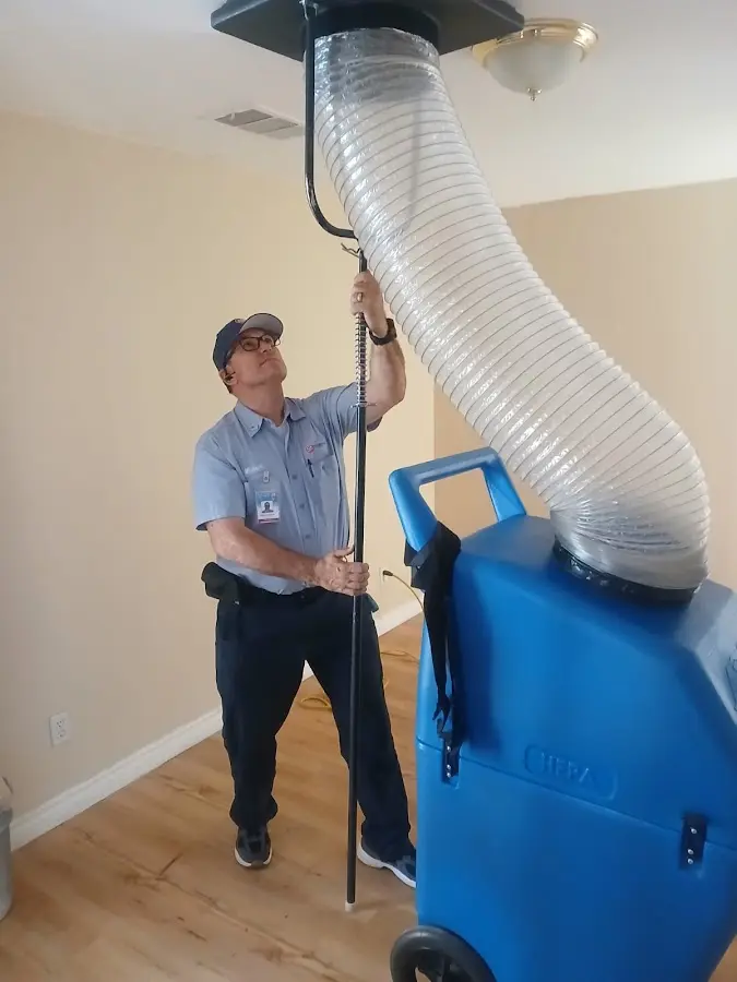 Furnace Tune-Up technician using HEPA equipment in Dinuba